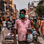 A man selling masks in the busy street of Varanasi during the pandemic.