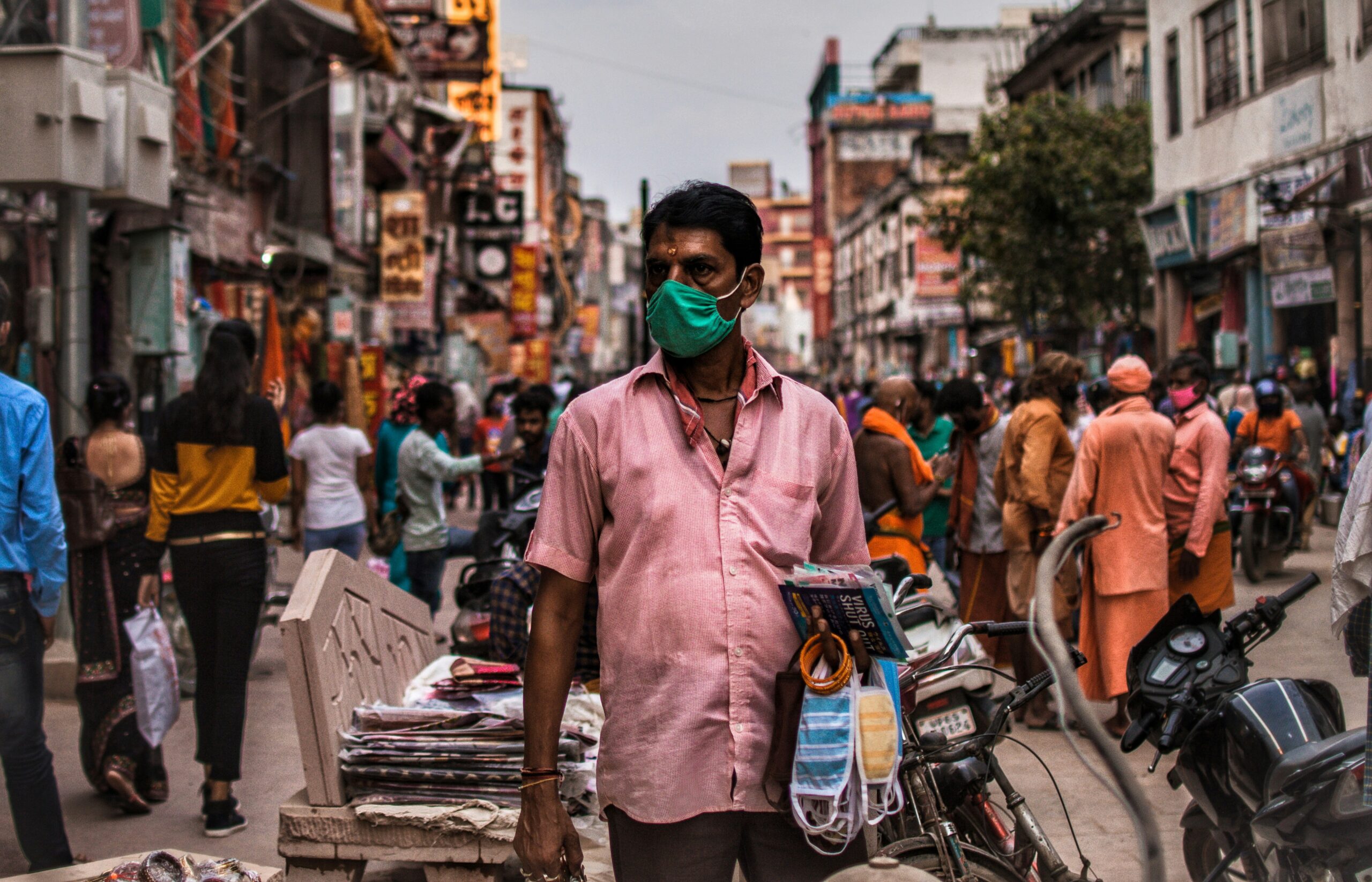 A man selling masks in the busy street of Varanasi during the pandemic.